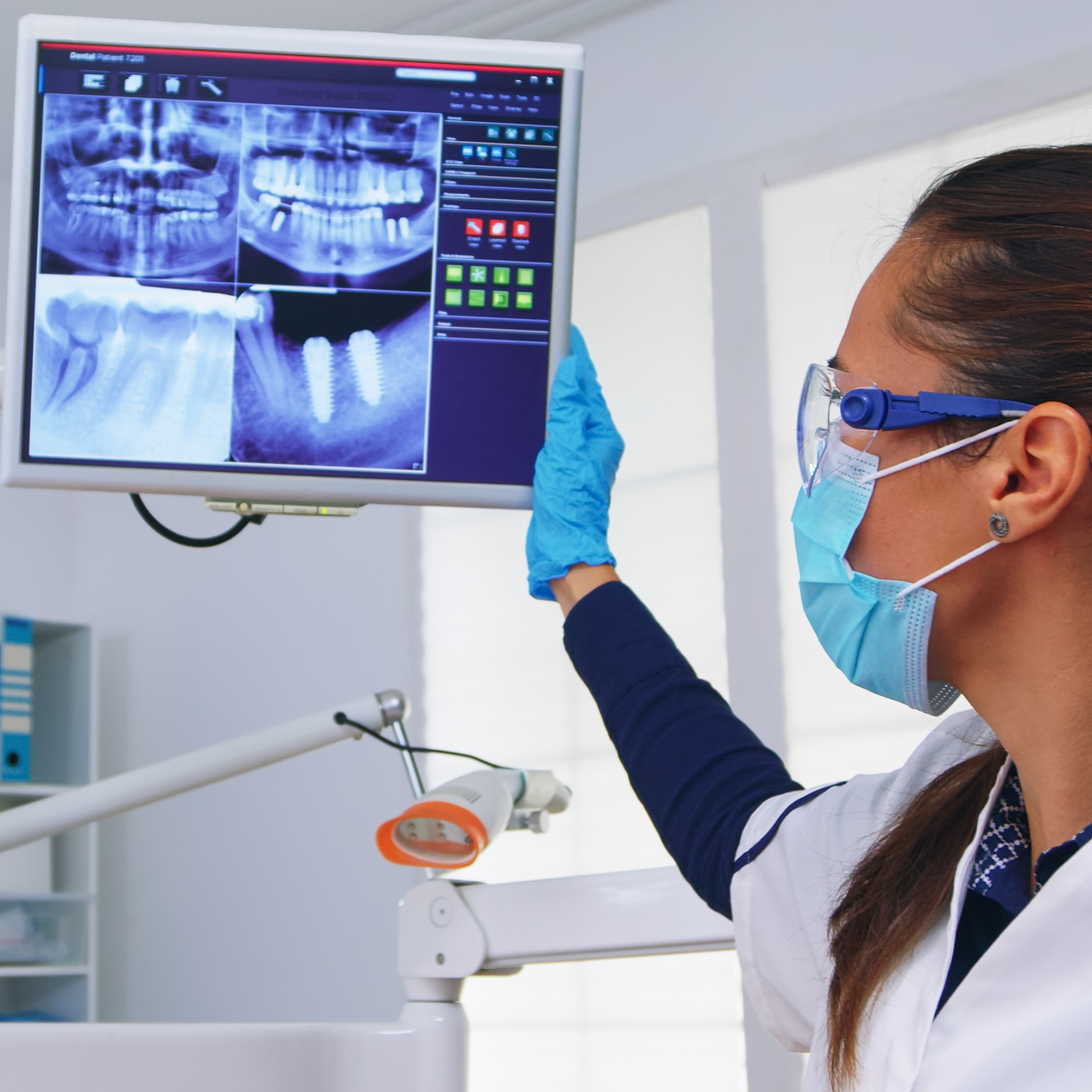 Image of a dentist looking at an x-ray